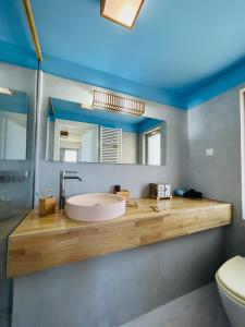 a bathroom with a sink and a mirror at Bella Mare Sitia in Sitia