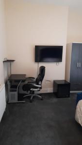 Habitación con escritorio, silla y ordenador. en Lovely Bedroom with Free parking en Walsall