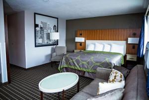 um quarto de hotel com uma cama e um sofá em Super 8 by Wyndham Holbrook em Holbrook