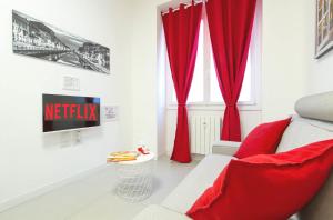 a living room with red curtains and a couch at Metro Plaza Apartment -Buenos Aires in Milan