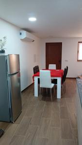 a dining room with a table and a refrigerator at Alojamento Local Casa da Eira in Murça