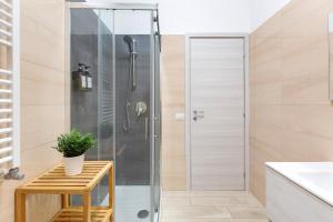 a shower with a glass door in a bathroom at Luciano Secret Garden Apartment in Rome +24 photos