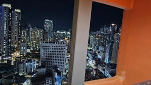 a view of a city at night from a window at The solid residence - Elbon the stay by haeundae in Busan