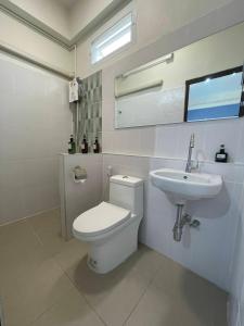 a white bathroom with a toilet and a sink at Self check-in apartment by Baiput Hometel in Phra Nakhon Si Ayutthaya