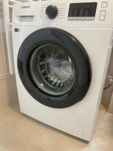 a white washing machine sitting in a room at Magnolia in Trnávka