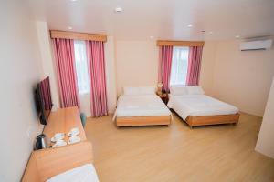 Postel nebo postele na pokoji v ubytování JVJ Hotel