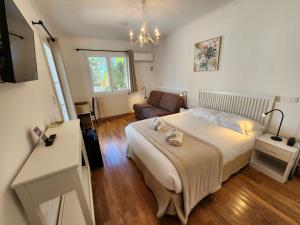 a bedroom with a large bed and a couch at Hôtel de Charme Brise Marine in Saint-Jean-Cap-Ferrat
