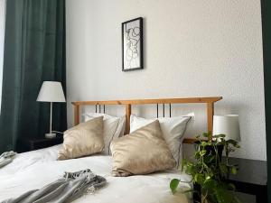 a bedroom with a bed with white sheets and pillows at Groundfloor Rahmaninov in Bucharest