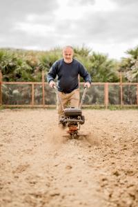 a man riding a dirt bike in the dirt at Kempinski Hotel San Lawrenz in San Lawrenz