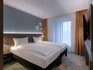 Postel nebo postele na pokoji v ubytování ibis Styles Kiel City