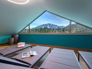 a room with two tables and a large window at ibis Styles Bad Reichenhall in Bad Reichenhall