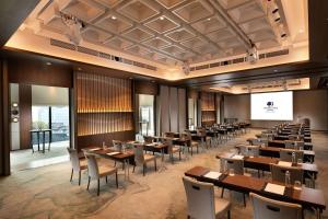 a dining room with tables and chairs and a screen at Doubletree By Hilton Osaka Castle in Osaka