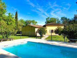 a swimming pool in front of a house at Terre de Sel in Grimaud