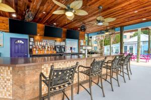 a bar with a row of chairs at a restaurant at Hilton Vacation Club Aqua Sol Orlando West in Orlando