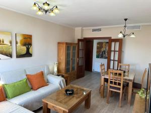 a living room with a couch and a table at Piso en Linares zona centro con parking gratis in Linares