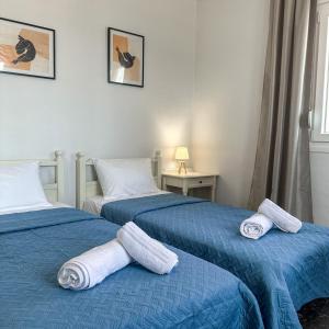 a room with two beds with towels on them at Alios apartment in Rhodes Town