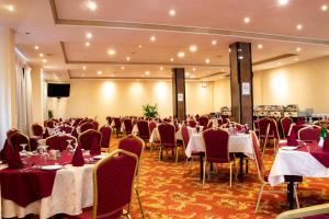 a banquet hall with tables and chairs in a room at Hotel Lakefield in Kandy