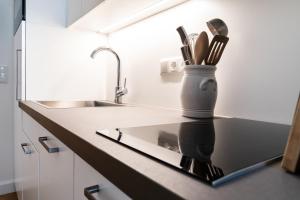 a kitchen counter with a knife holder with utensils at twenty five - work & life Apartments in Amstetten