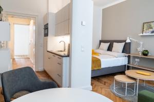 a small apartment with a bed and a kitchen at twenty five - work & life Apartments in Amstetten