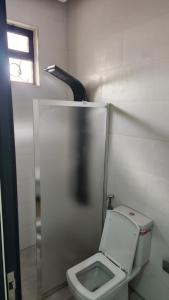 ein Badezimmer mit einem weißen WC in einer Kabine in der Unterkunft ROSE in Umm el ‘Amad