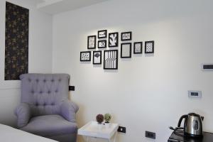 Pokój z niebieskim krzesłem i obrazami na ścianie w obiekcie 悅柏行旅 逢甲館 YABO Inn w mieście Taizhong