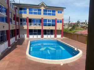 einem großen Pool vor einem Gebäude in der Unterkunft Crislord Palace Hotel in Takoradi