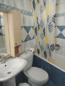 a bathroom with a white toilet and a sink at My Aunts House in Agios Nikolaos +45 photos