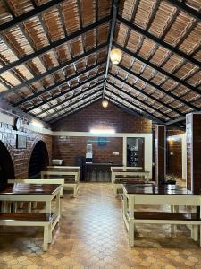 a room with wooden tables and benches in a building at Ammara Eco Stays in Avathi