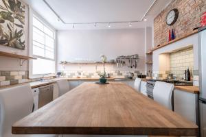 a large kitchen with a wooden table and chairs at Designer Maisonette Whole Apartment in Brighton & Hove