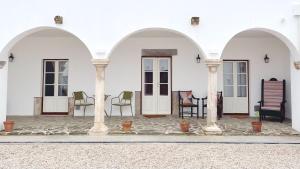 a group of three arches on a white building at Senhora da Praça in Gavião +18 photos