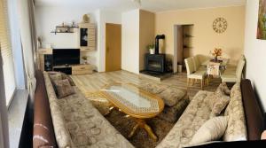 a living room with a couch and a table at Summer house LejHana in Bihać