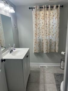 a bathroom with a sink and a shower curtain at Room near the beach in long branch in Long Branch