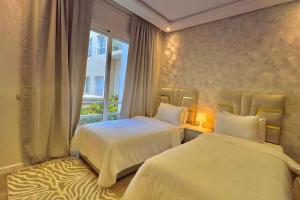 A bed or beds in a room at E4 Luxury Appartement La Corniche Rabat - Essabah