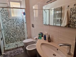 a bathroom with a sink and a toilet and a shower at Novoli Chic: Cuore di Firenze in Florence