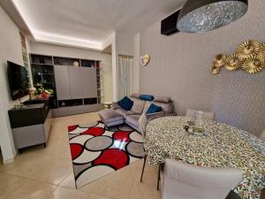 a living room with a table and a couch at Novoli Chic: Cuore di Firenze in Florence