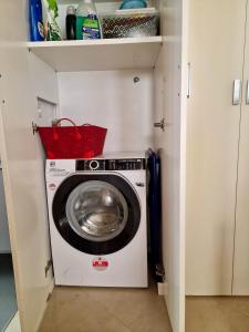 a washer and dryer in a small kitchen at Novoli Chic: Cuore di Firenze in Florence