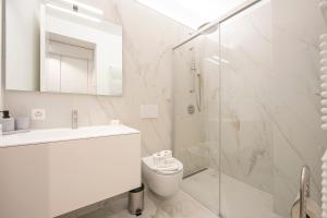 a bathroom with a toilet and a sink and a shower at Res San Marco 1 - Happy Rentals in Lugano