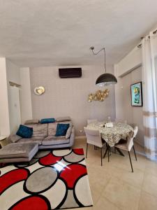 a living room with a bed and a dining table at Novoli Chic: Cuore di Firenze in Florence