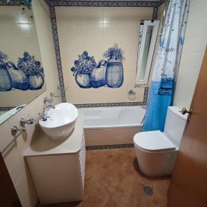 a bathroom with a sink and a toilet and a tub at CastelloHouse, The Best Sea View, in front of Carvoeiro beach in Carvoeiro +149 photos
