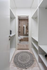 a bathroom with a shower and a toilet and a rug at RA FIGUEIRA DA FOZ in Figueira da Foz