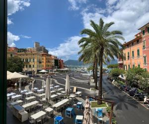 a street with tables and chairs and a palm tree at Cuore di Lerici , amazing view in Lerici