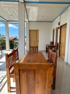 a dining room with a wooden table and chairs at FOUR-G HOMESTAY & Komodo Tour in Labuan Bajo