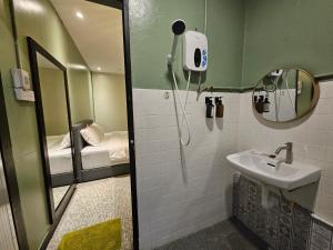 a small bathroom with a sink and a mirror at 85 Boutique Hotel in Ipoh
