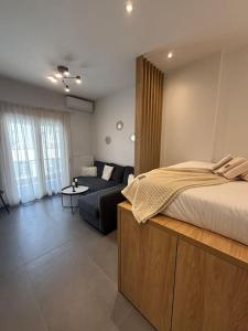a bedroom with a bed and a couch in a room at Thessalonian Suite I - 2 Steps from White Tower in Thessaloniki
