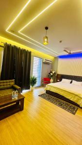 a large bedroom with a bed and a couch at Star Comfort Inn in Lucknow