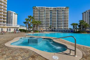 a swimming pool in front of a large apartment building at St. Lucia 704 in Destin