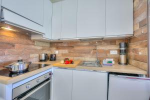 a kitchen with white cabinets and a sink at Casa Bruna Few Min From Lake - Happy Rentals in Caslano