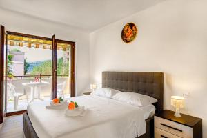 a bedroom with a large bed and a balcony at Casa Bruna Few Min From Lake - Happy Rentals in Caslano