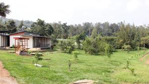 a yard with a house and a field with trees at DON BOSCO HOSPITALITY CENTRE KIGALI Ltd in Kigali