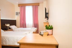 Postel nebo postele na pokoji v ubytování JVJ Hotel